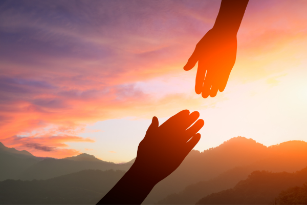 Helping Hands with a sunset background - The Hope Connection